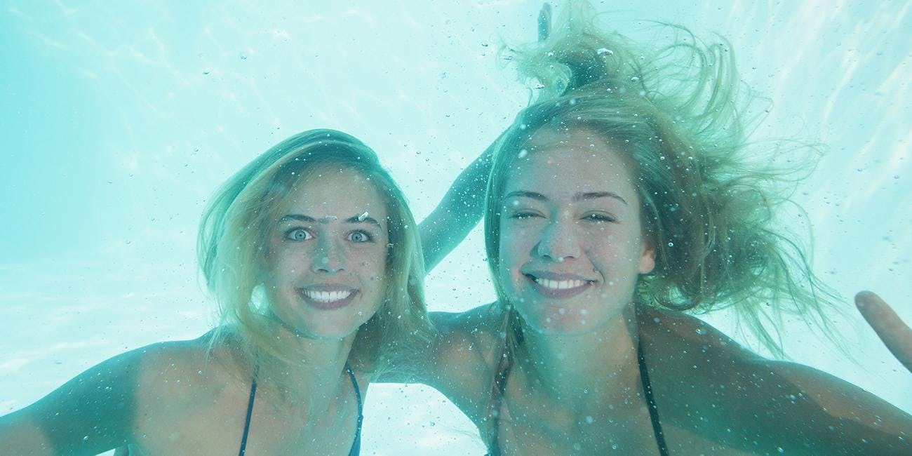 Why does hair turn green in swimming pools?