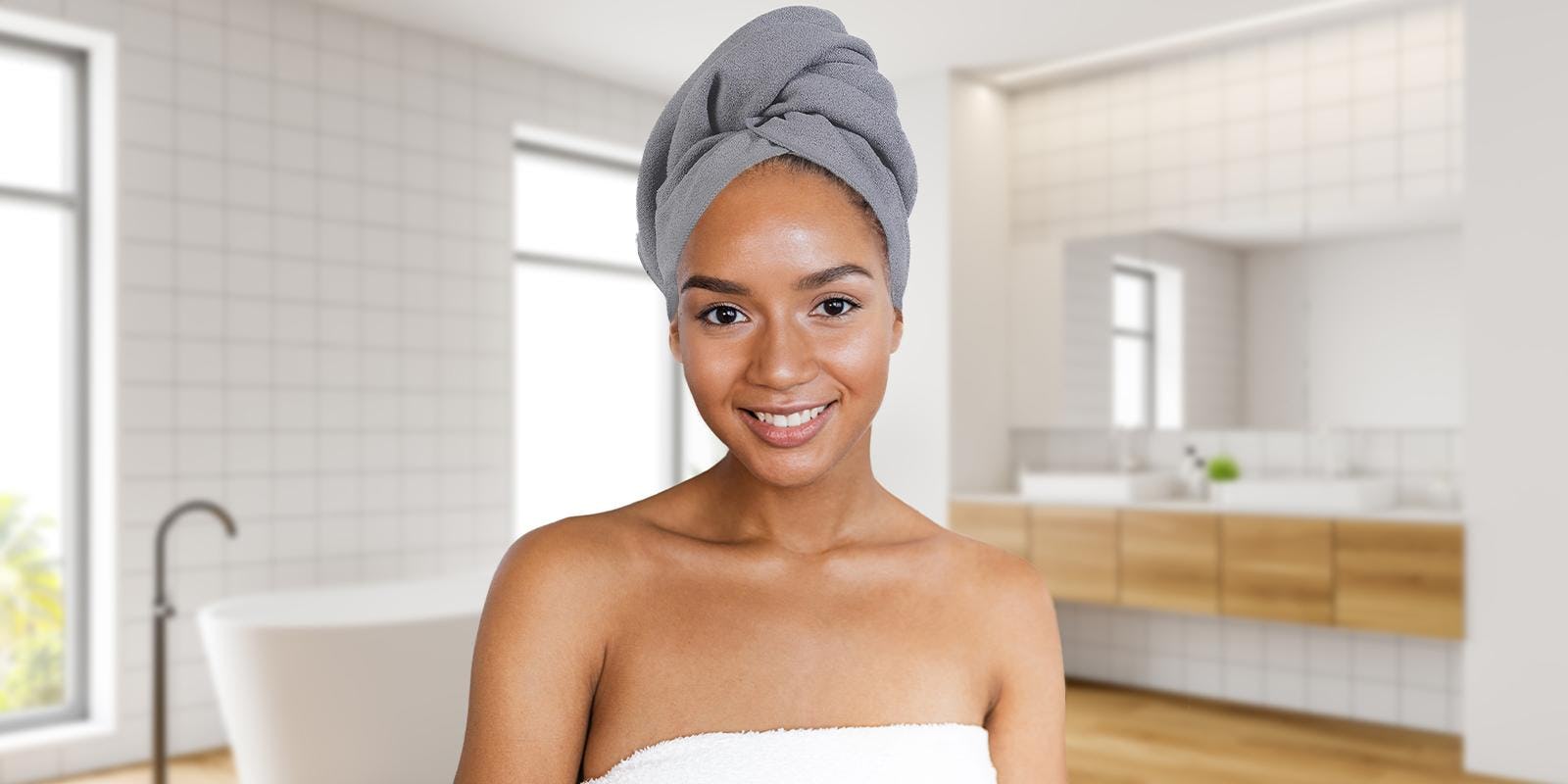 Woman smiling with hair tied up in towel