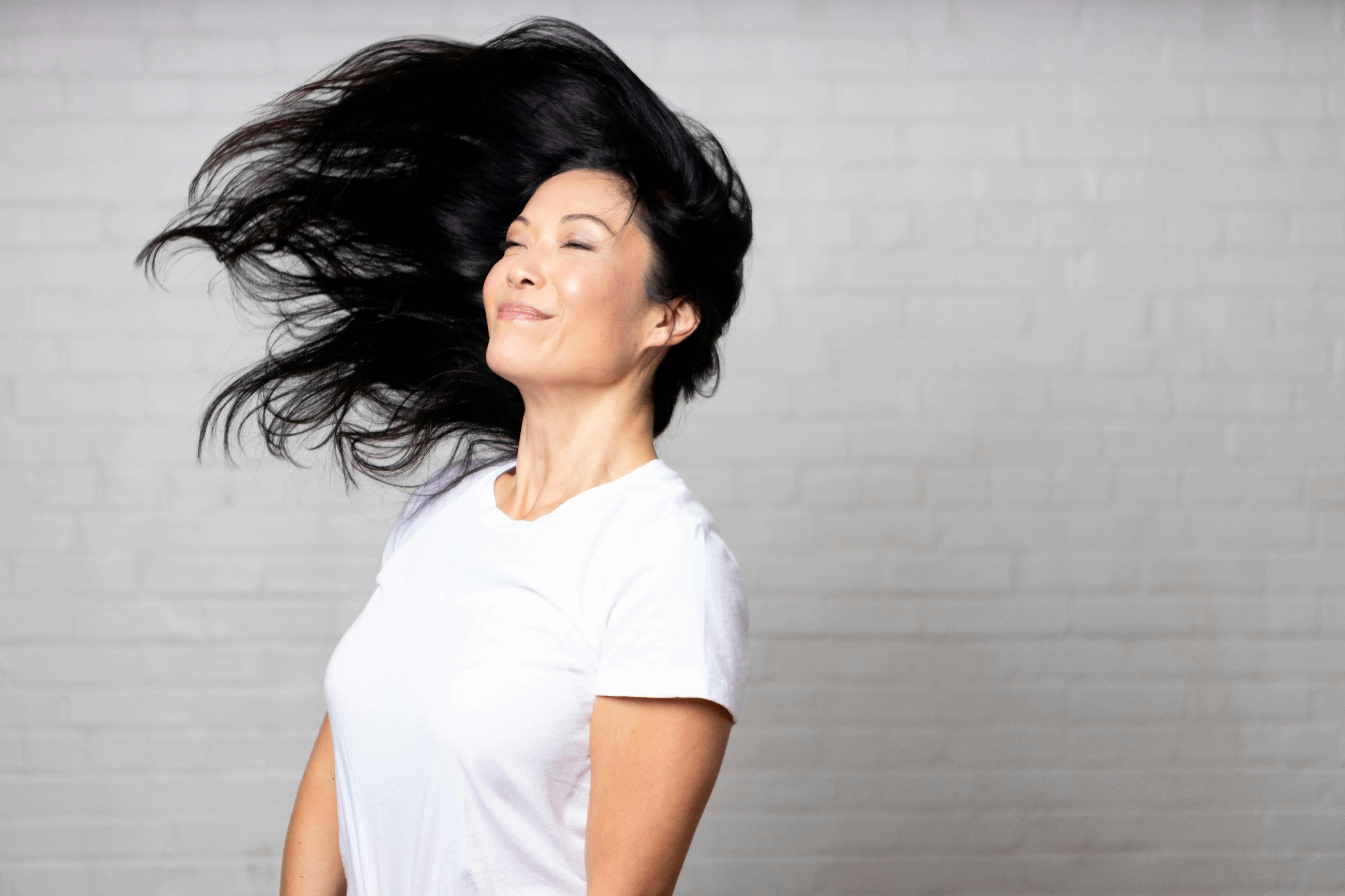 Smiling woman with hair blowing