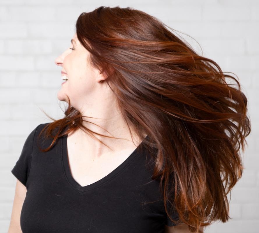 Woman with long red hair smiling